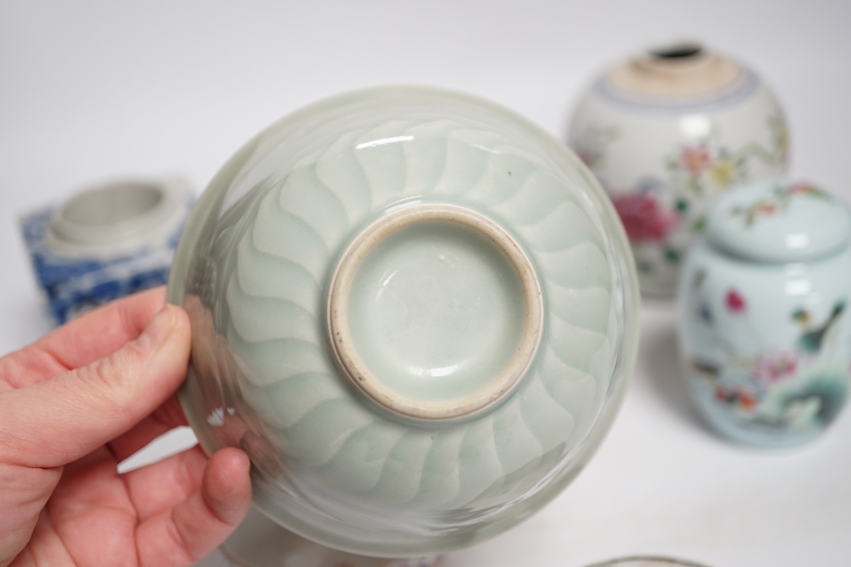 A collection of Chinese ceramics including celadon bowl decorated in low relief with fish, famille rose tea bowls and a jar, largest 12cm high